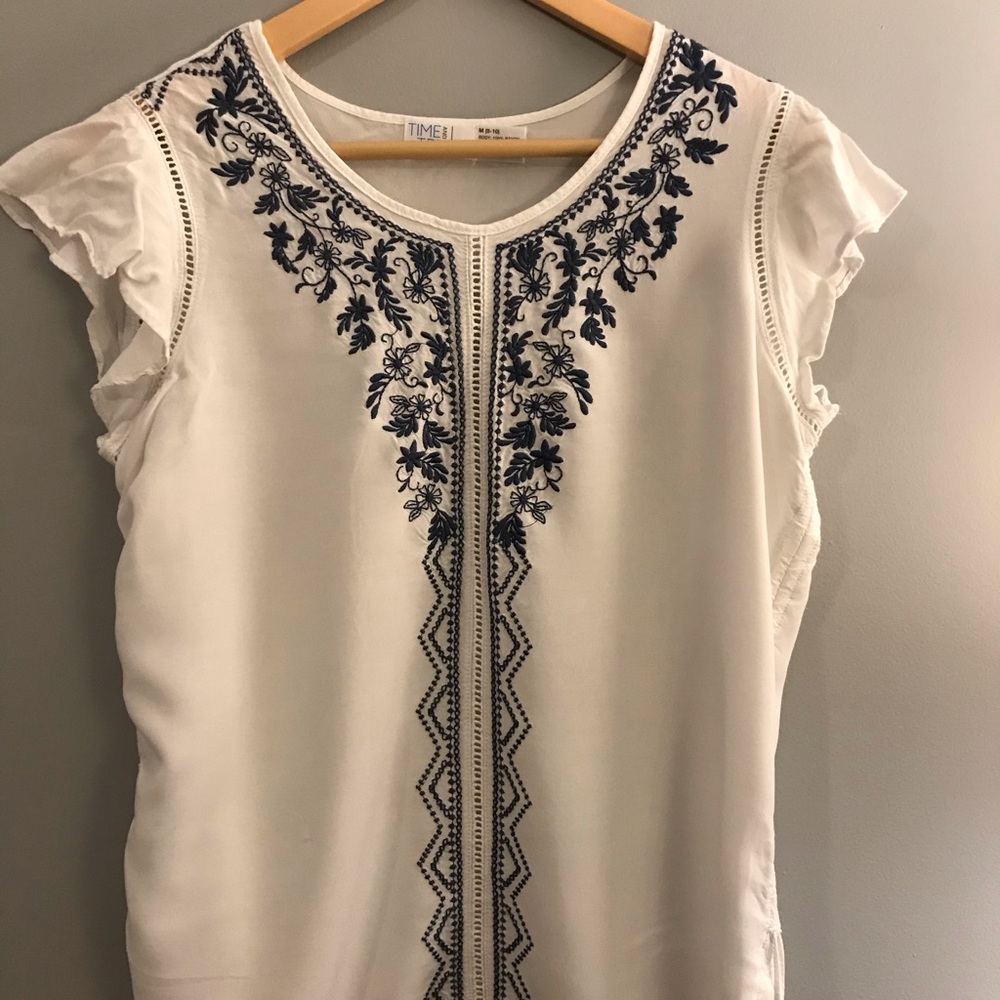 White blouse with blue embroidery
